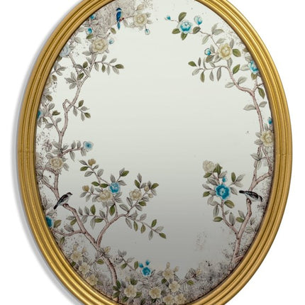 Decorative oval mirror with floral and bird design in a gold frame on a white background - Elderflower Lane