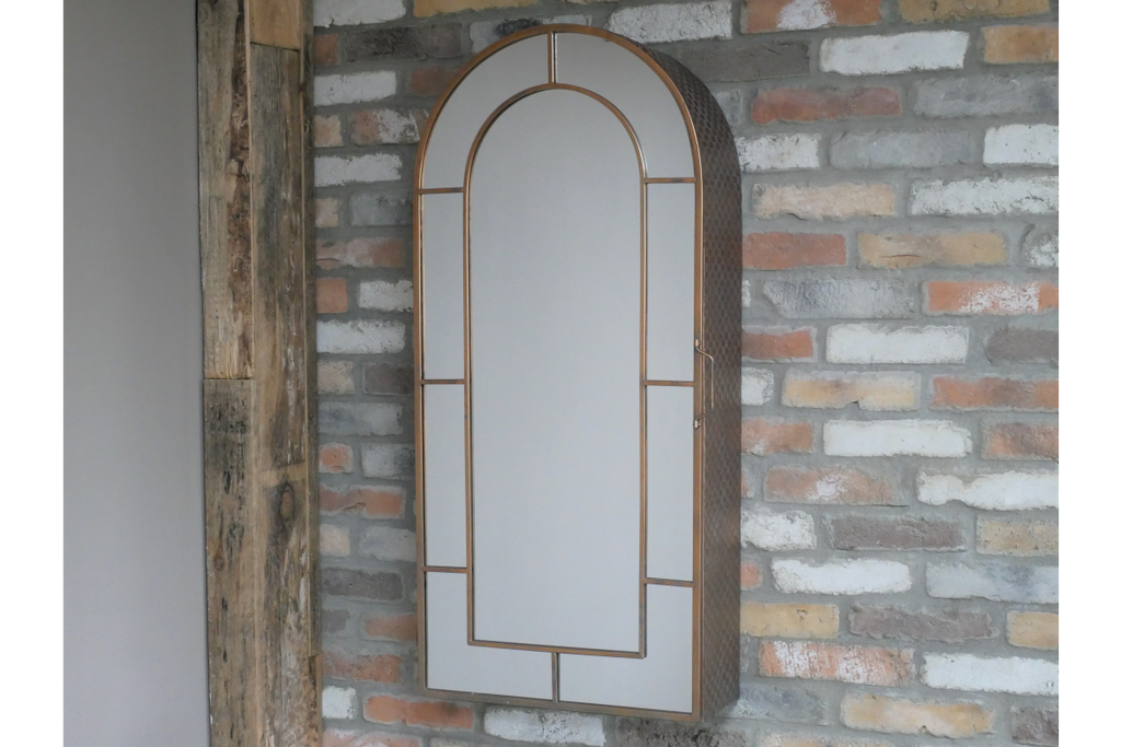 Tall mirrored arched copper wall storage cabinet.
