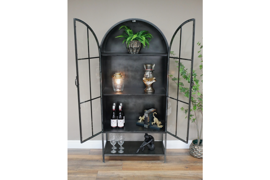 Arched tall slim glass fronted black metal storage display cabinet.