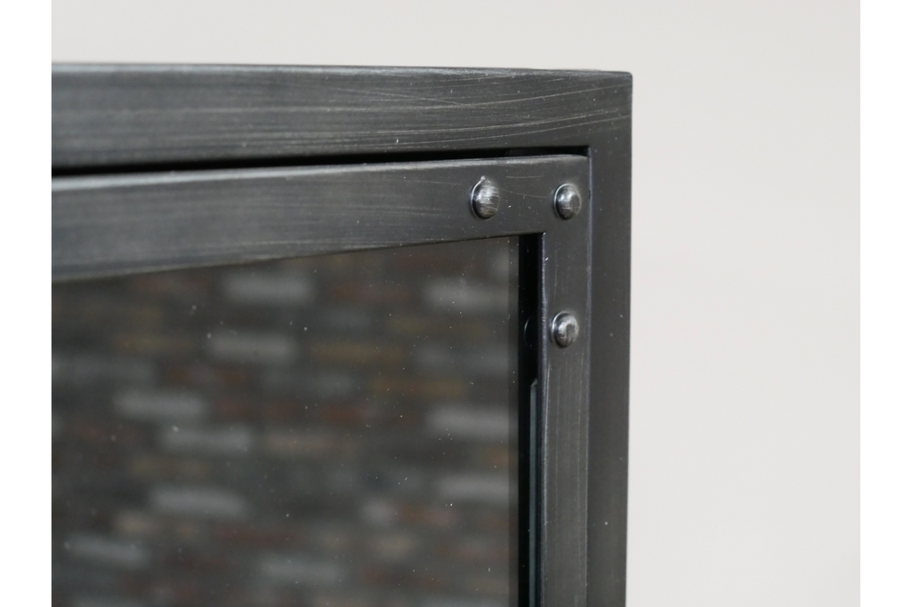 Tall slim glass fronted black metal display cabinet.