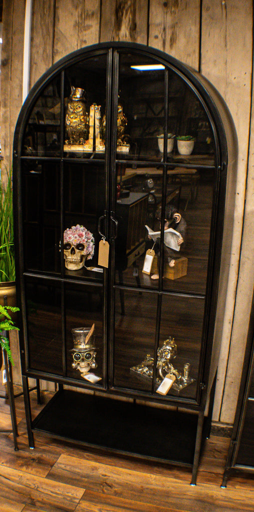 Arched tall slim glass fronted black metal storage display cabinet.