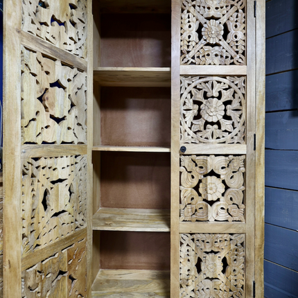 Tall ornate carved natural wood storage cupboard