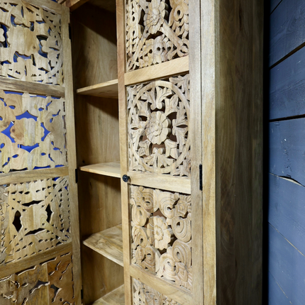 Tall ornate carved natural wood storage cupboard