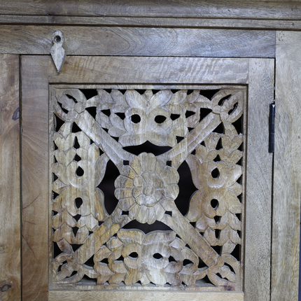 Tall ornate carved natural wood storage cupboard