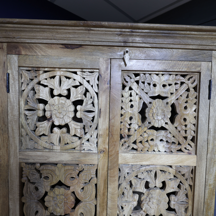 Tall ornate carved natural wood storage cupboard