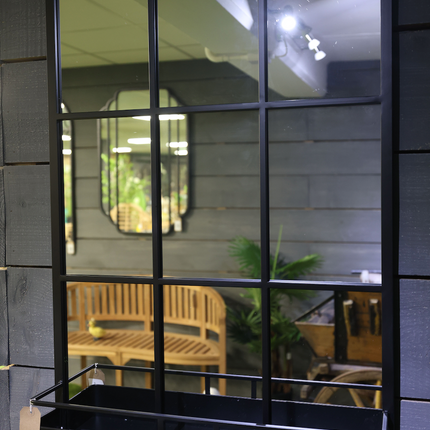 Tall black metal wall mirror with storage shelf