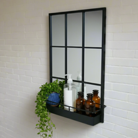 Tall black metal wall mirror with storage shelf
