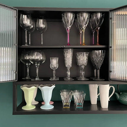 Black metal wide wall storage cabinet with ribbed glass double doors