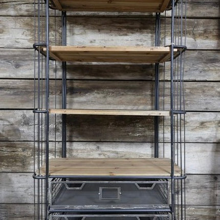 Metal shelving unit with wooden shelves against a wooden wall.